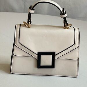 Elegant Cream Handbag with Black Accents